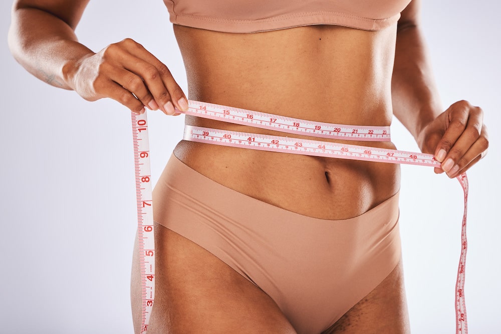 measuring tape stomach and woman in studio for we 2023 02 08 02 56 18 utc