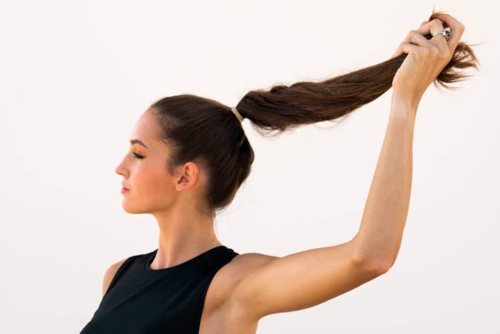 woman pulling out her ponytail on a white backgrou 2022 11 15 02 20 16 utc