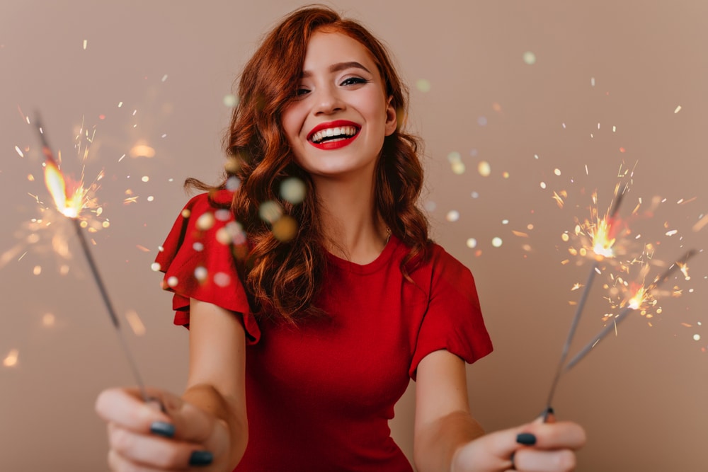 Woman celebrating the New Year with youthful, vibrant skin from Sculptra treatment.