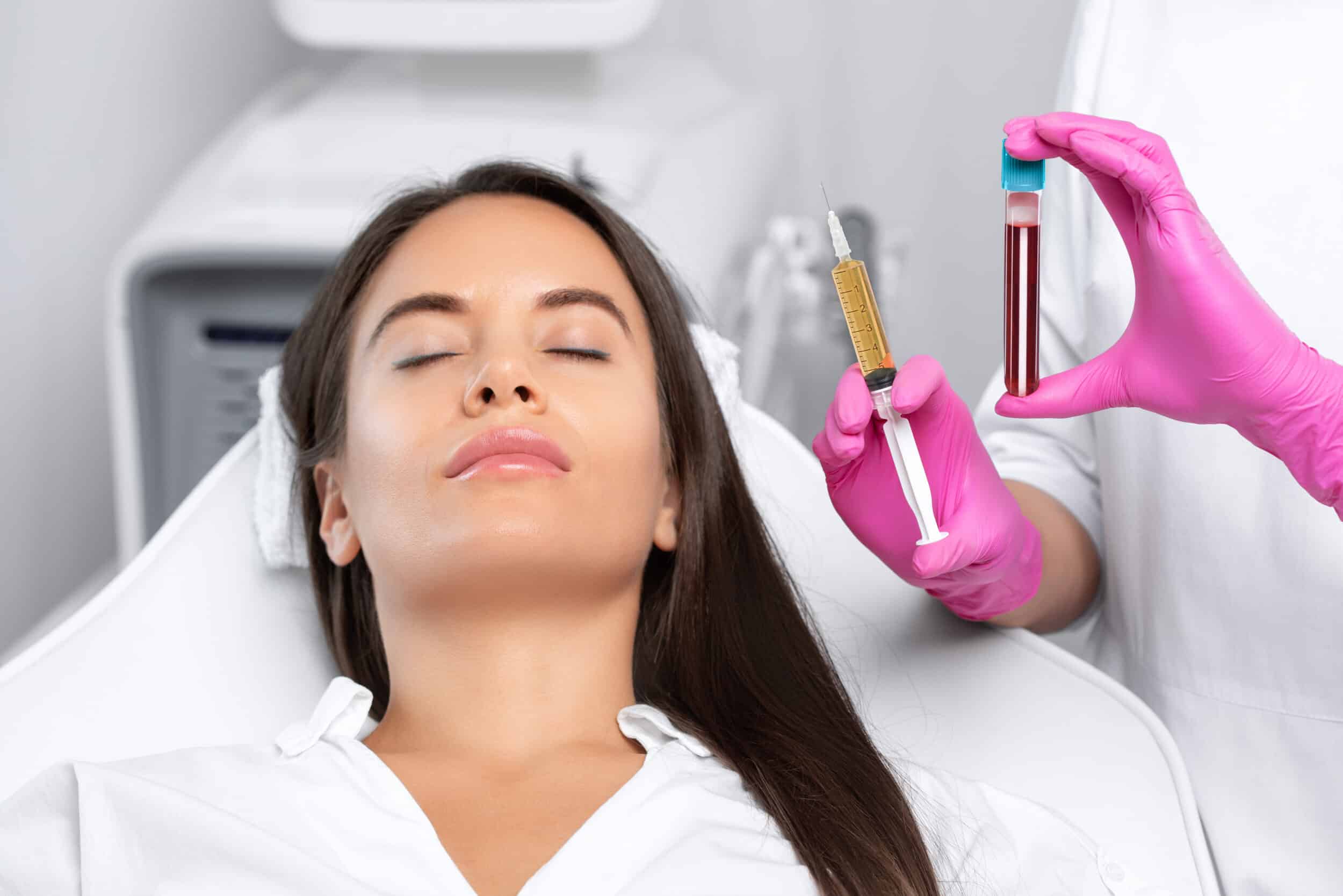 Patient laying down with a provider next to her preparing the PRP hair restoration injections