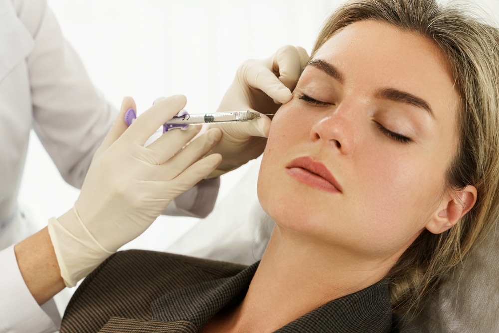 Close up of a beautiful woman getting dermal filler injections from an expert provider.