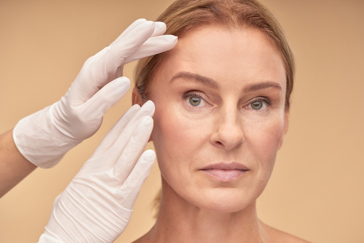 Middle-aged woman receiving Daxxify injections around her eyes to gently help soften fine lines and wrinkles. Middle-aged woman receiving Daxxify injections around her eyes to gently help soften fine lines and wrinkles.
