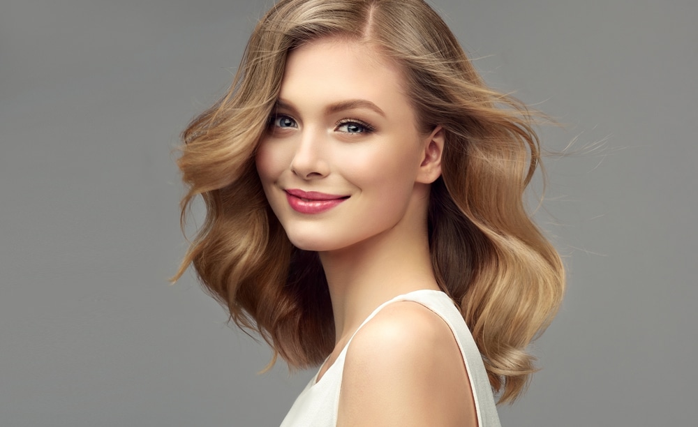 Woman with bright, healthy-looking skin illustrating the benefits of chemical peels for sun damage.