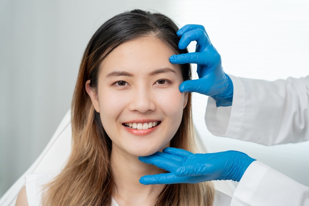 Woman receiving a facial dermal filler consultation and treatment to improve visible signs of facial aging.